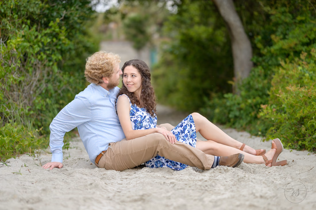 Couple sitting together on the sandy beach path - Huntington Beach State Park