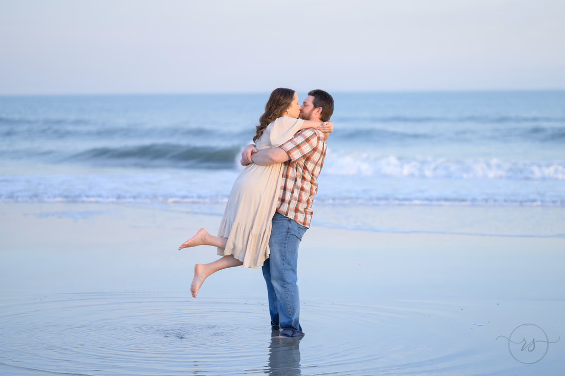 He lifts her off her feet for a kiss by the ocean - Huntington Beach State Park