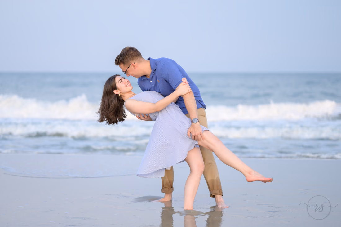 He dips her back in the shallow water - Huntington Beach State Park