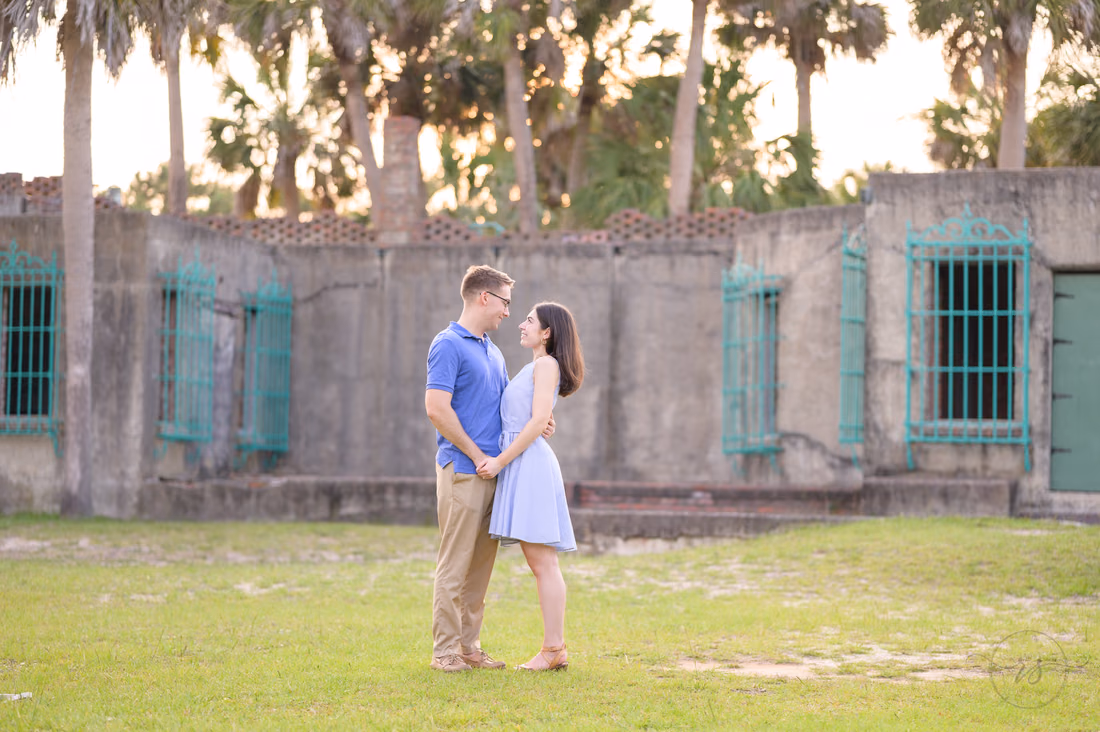 Couple face to face on the lawn in front of Atalaya Castle - Huntington Beach State Park