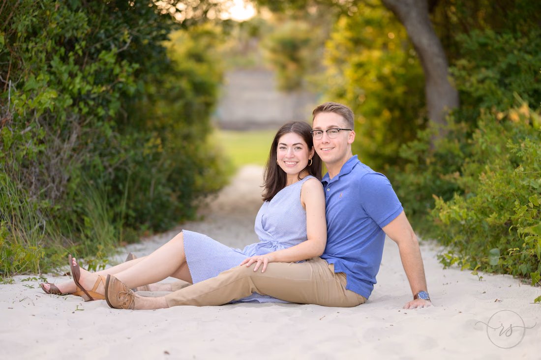Couple sitting together on the sandy beach path - Huntington Beach State Park