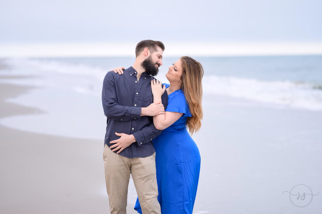 Couple hugging and smiling by the ocean - Huntington Beach State Park