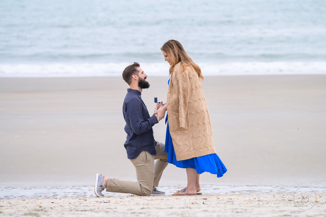 Surprise proposal and engagement pictures on a cloudy day - Huntington Beach State Park