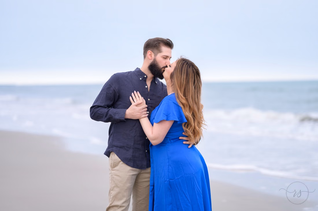 Couple kissing by the ocean right after the proposal - Huntington Beach State Park