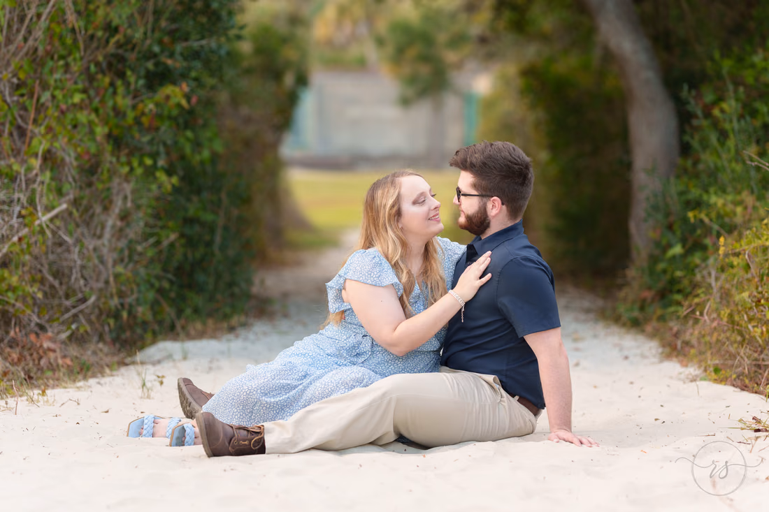 Couple sitting together on the sandy beach path - Huntington Beach State Park
