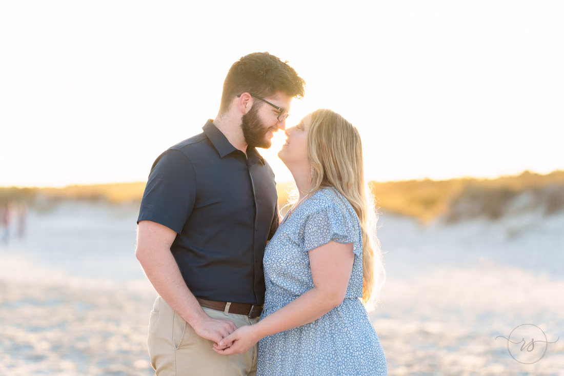 Couple nose to nose in the winter sunset - Huntington Beach State Park