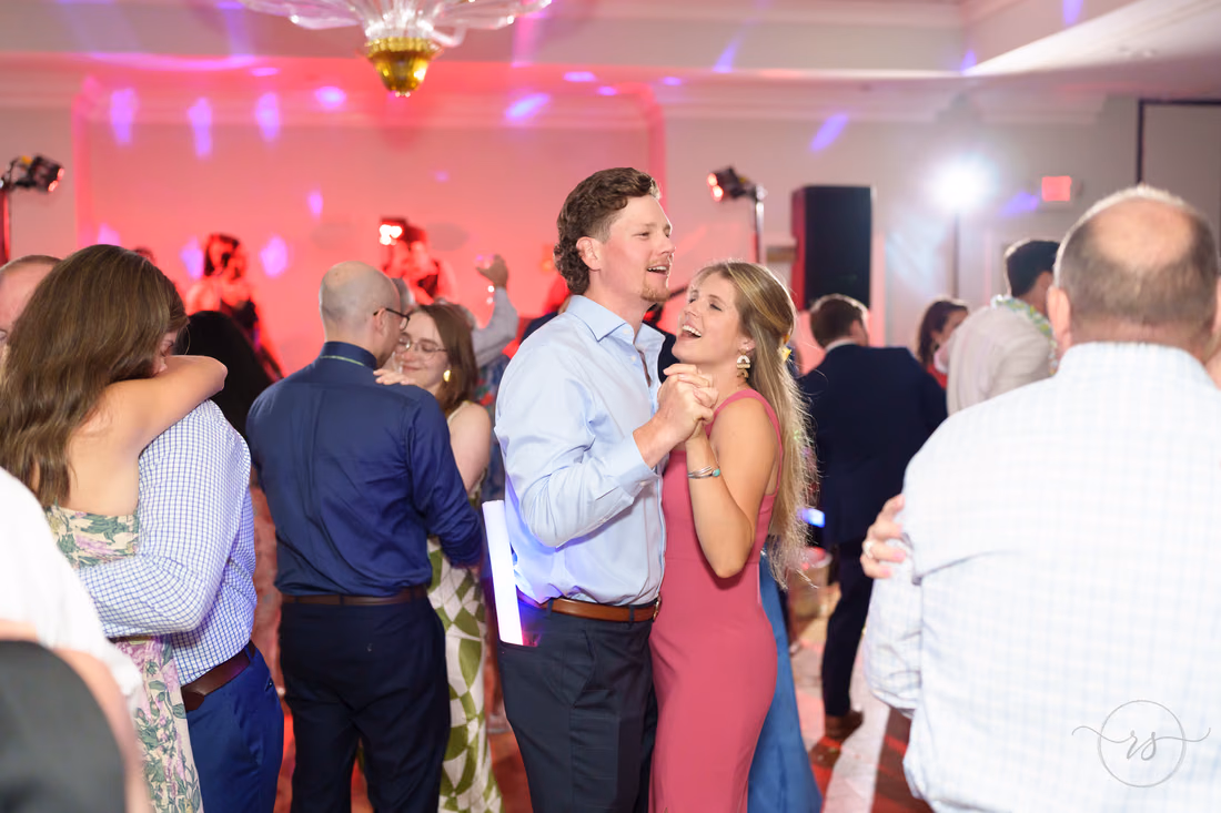 Couples slow dance under colorful party lights at Pawleys Plantation