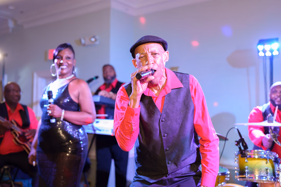 Band singer in a cap performs into the microphone at Pawleys Plantation