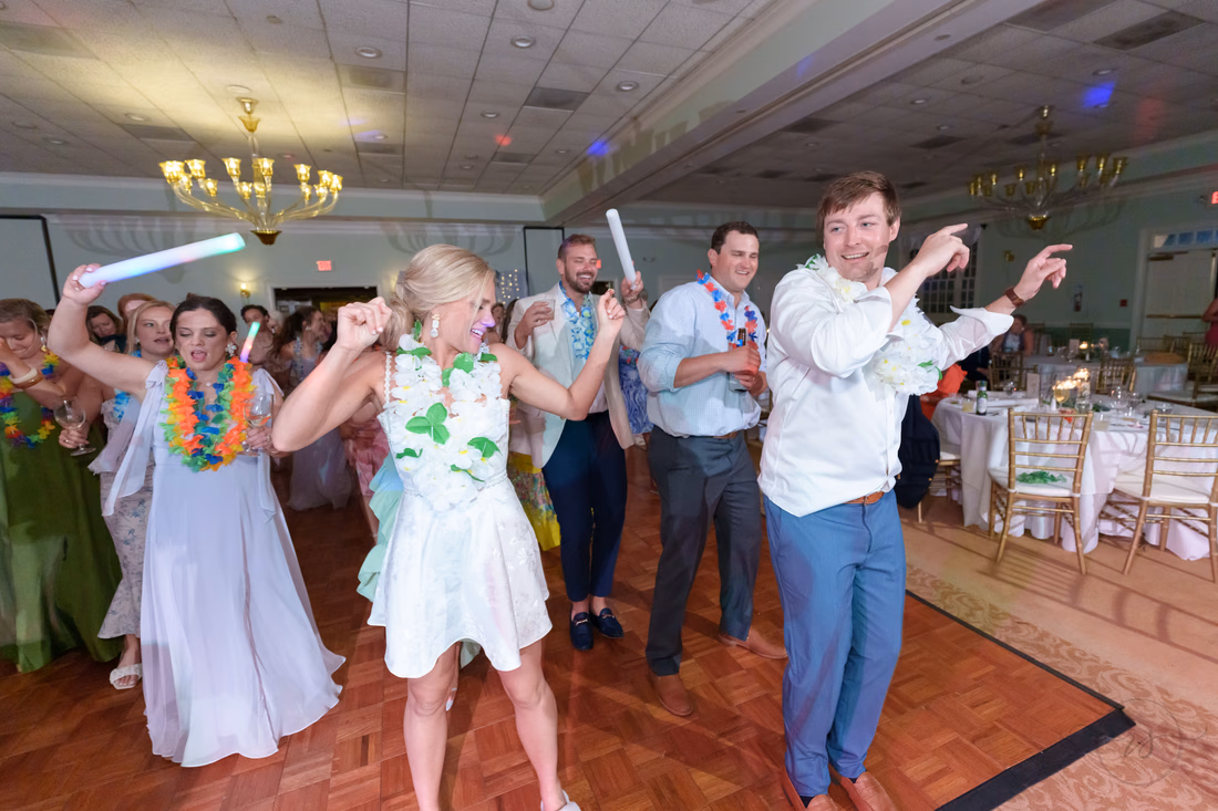 Bride and groom lead a group dance with light-up foam sticks at Pawleys Plantation