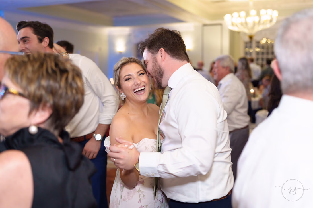 A guest laughs while dancing with a partner at the reception at Pawleys Plantation