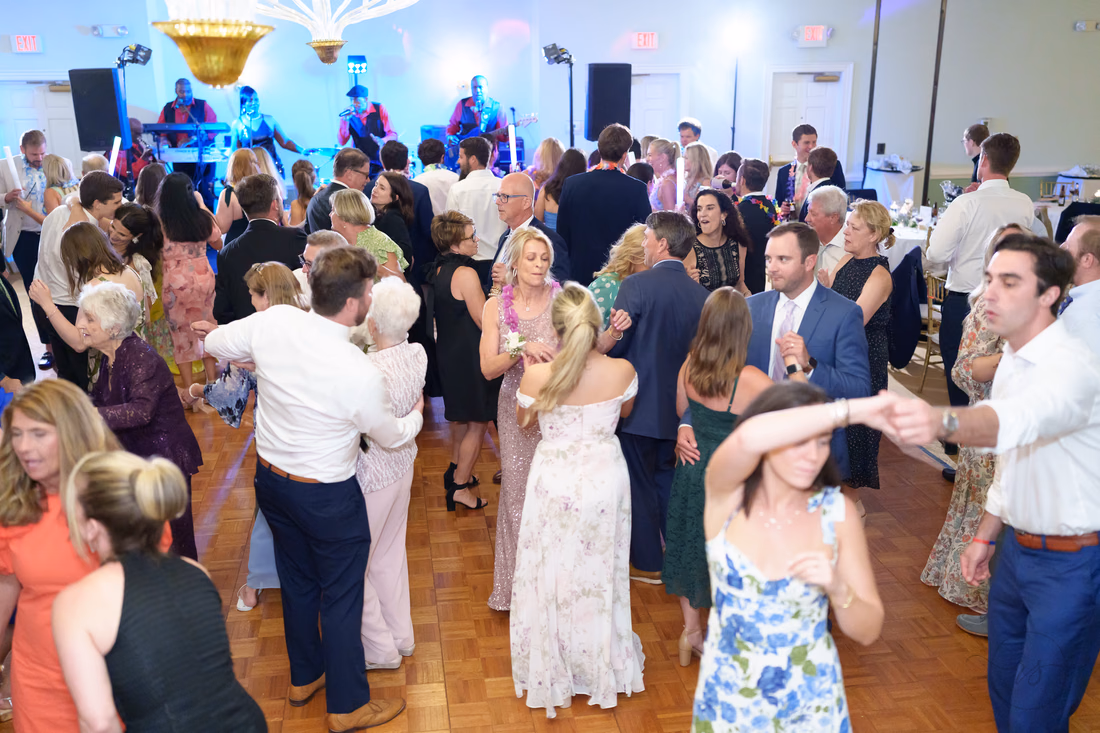 Guests twirl and dance in front of the band at Pawleys Plantation