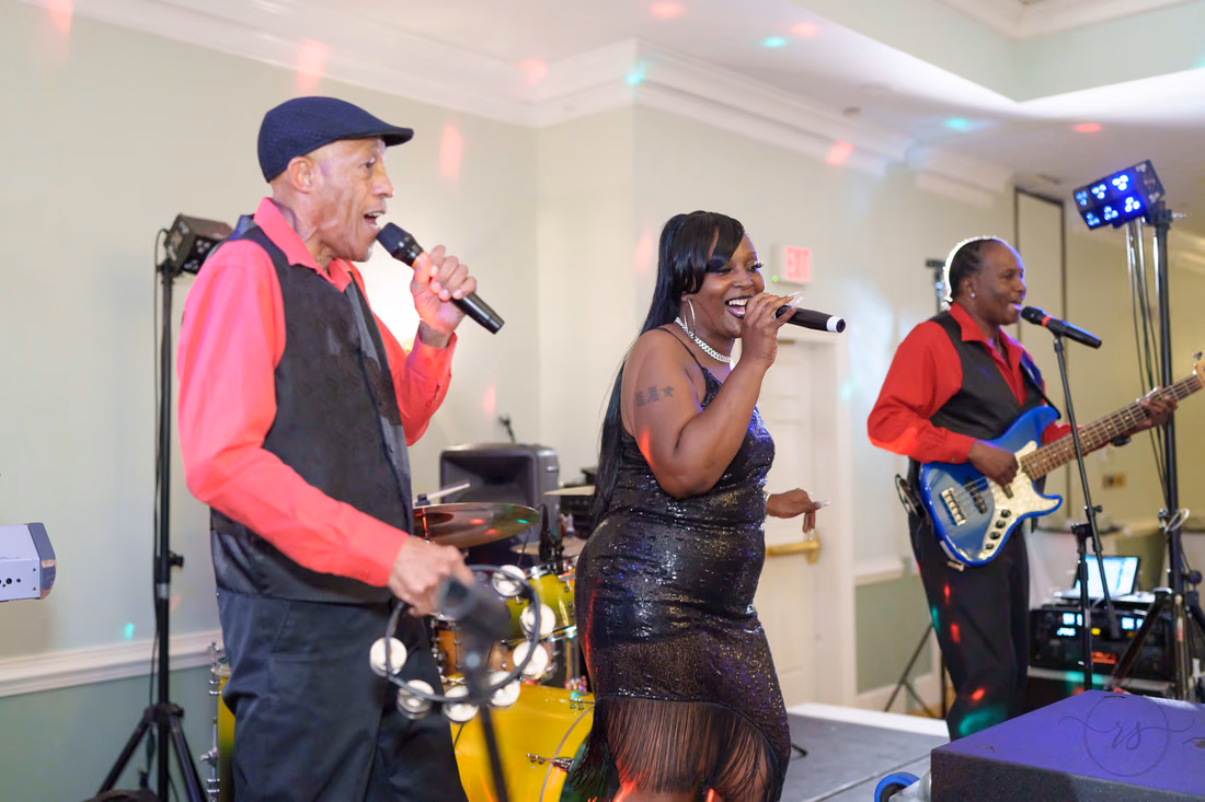 Band singers and bassist perform on stage at the reception at Pawleys Plantation