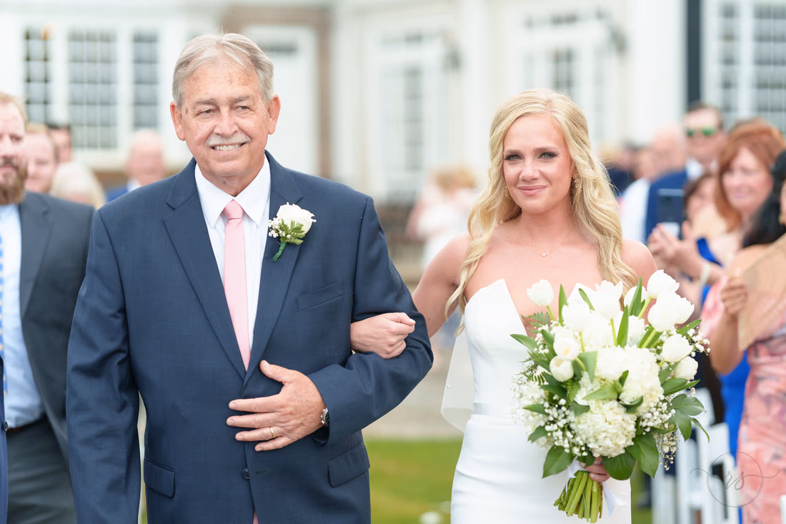 Bride and her father smile as they reach the end of the aisle at Pawleys Plantation