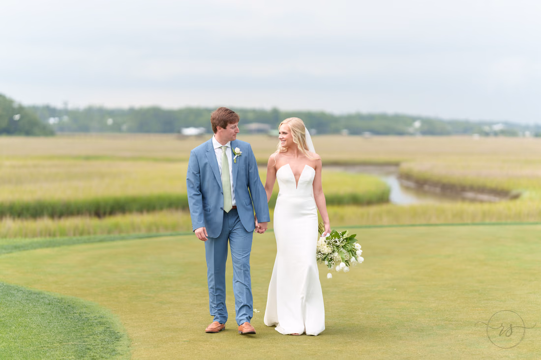 Bride and groom walking together down the golf course - Pawleys Plantation