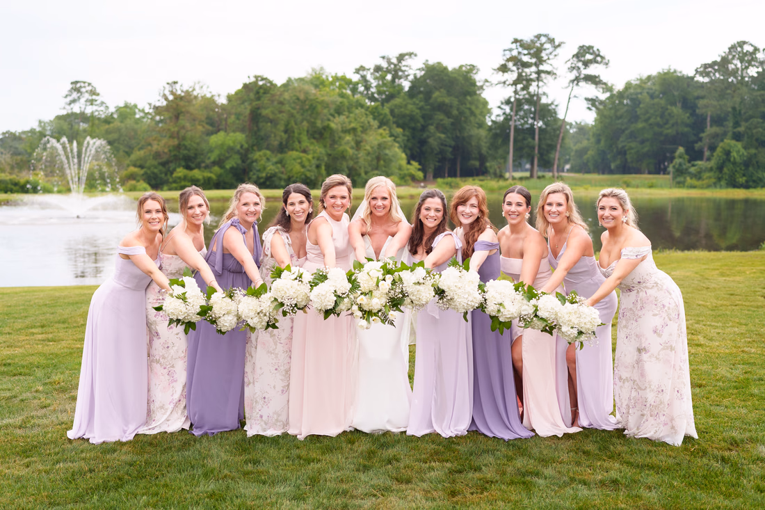 Bridesmaids holding the flowers together - Pawleys Plantation