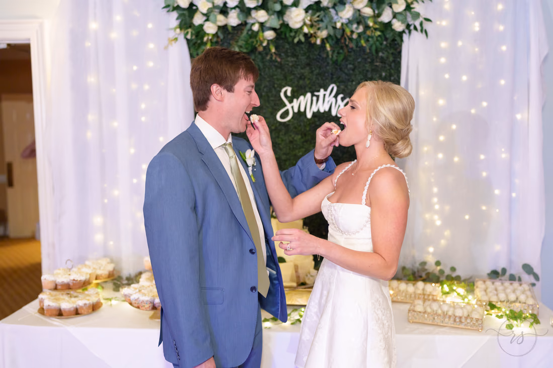 Groom feeds the bride a bite of wedding cake at Pawleys Plantation