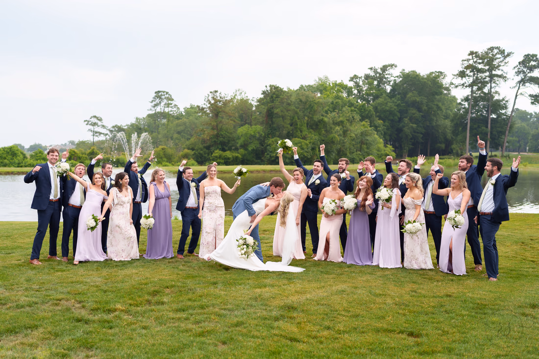 Dip back for a kiss with big wedding party - Pawleys Plantation