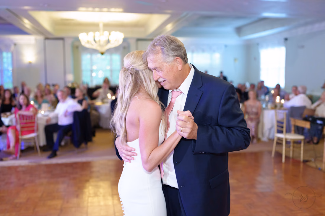 Bride and her father dance close in the ballroom at Pawleys Plantation