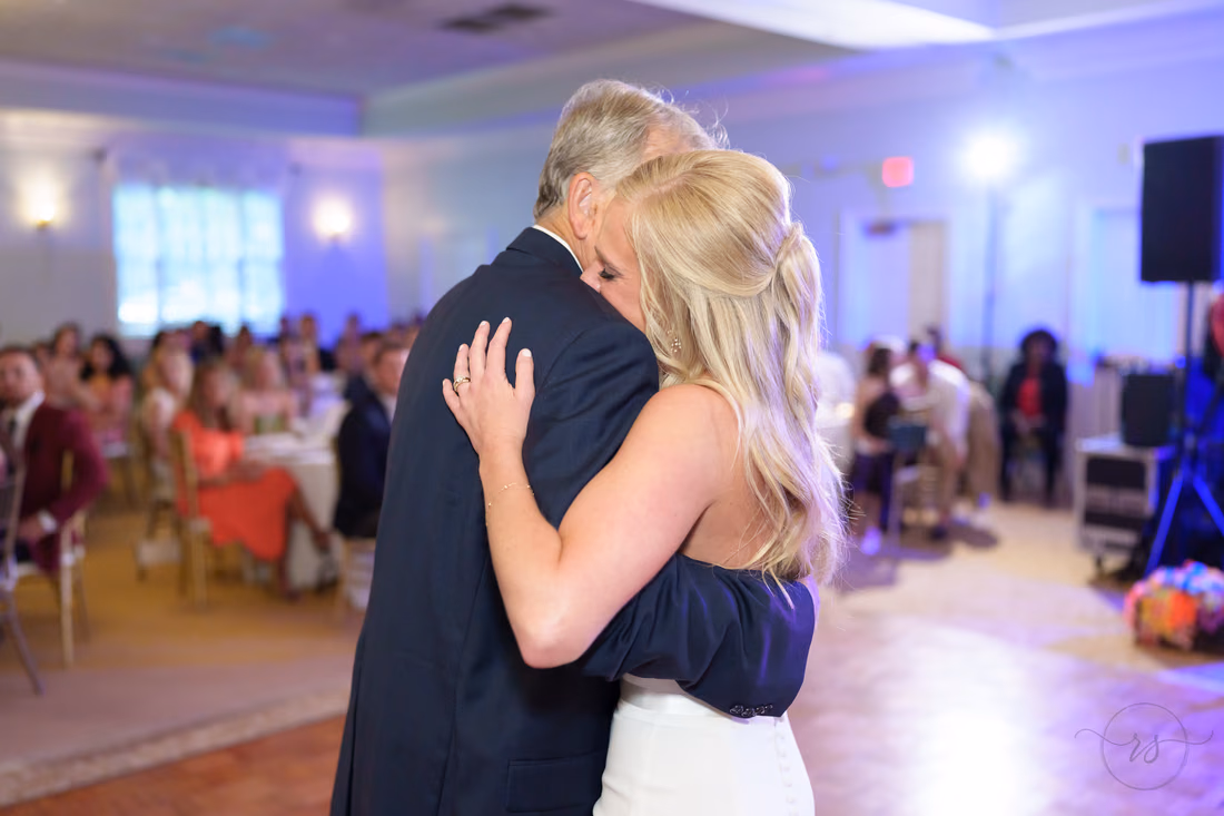 Bride hugs her father during their dance at Pawleys Plantation