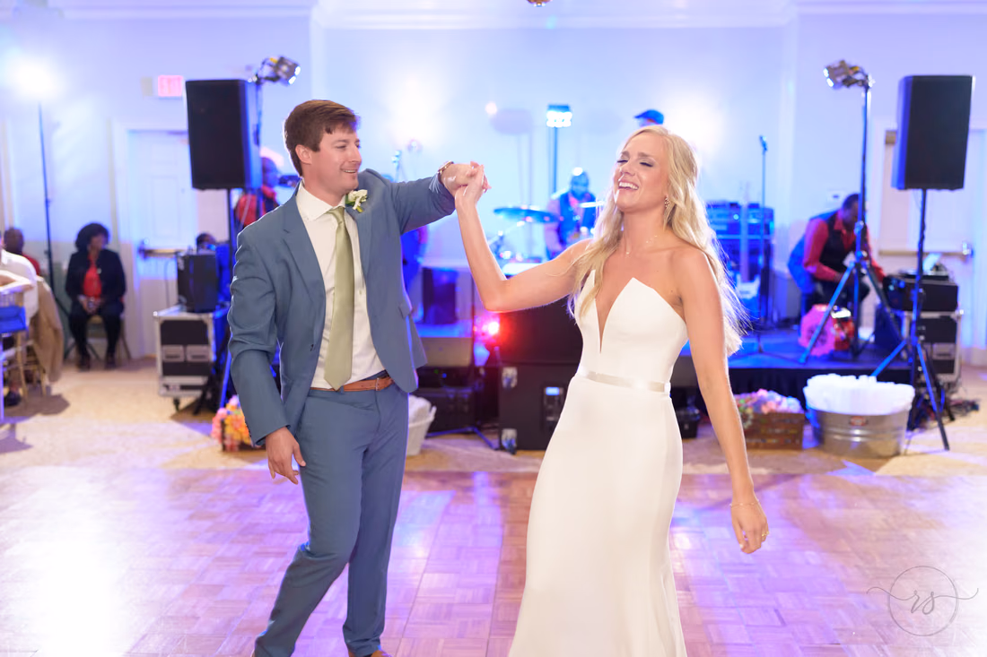 Groom spins the bride during their first dance with the band at Pawleys Plantation