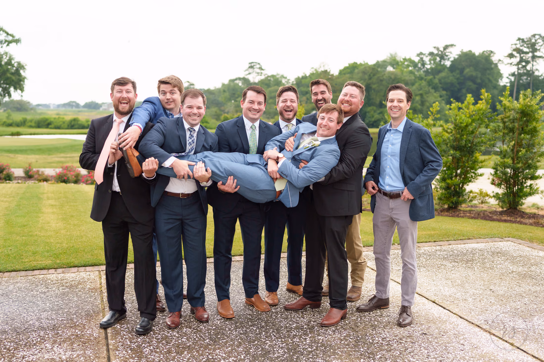 Friends lifting up the groom - Pawleys Plantation