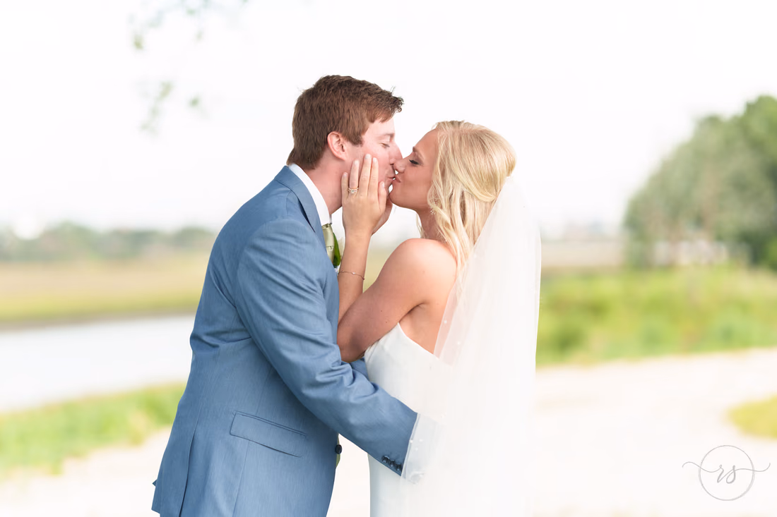 Hands on the groom's face showing off the ring - Pawleys Plantation