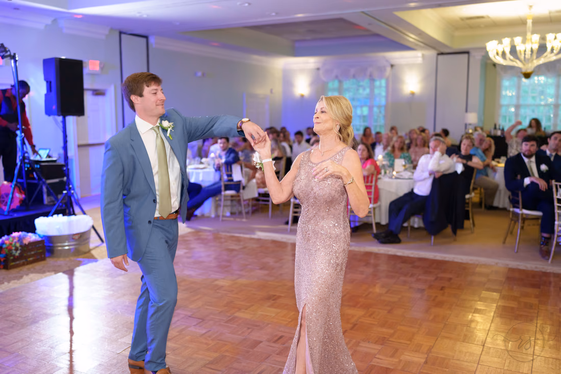 Groom twirls his mother on the dance floor at Pawleys Plantation