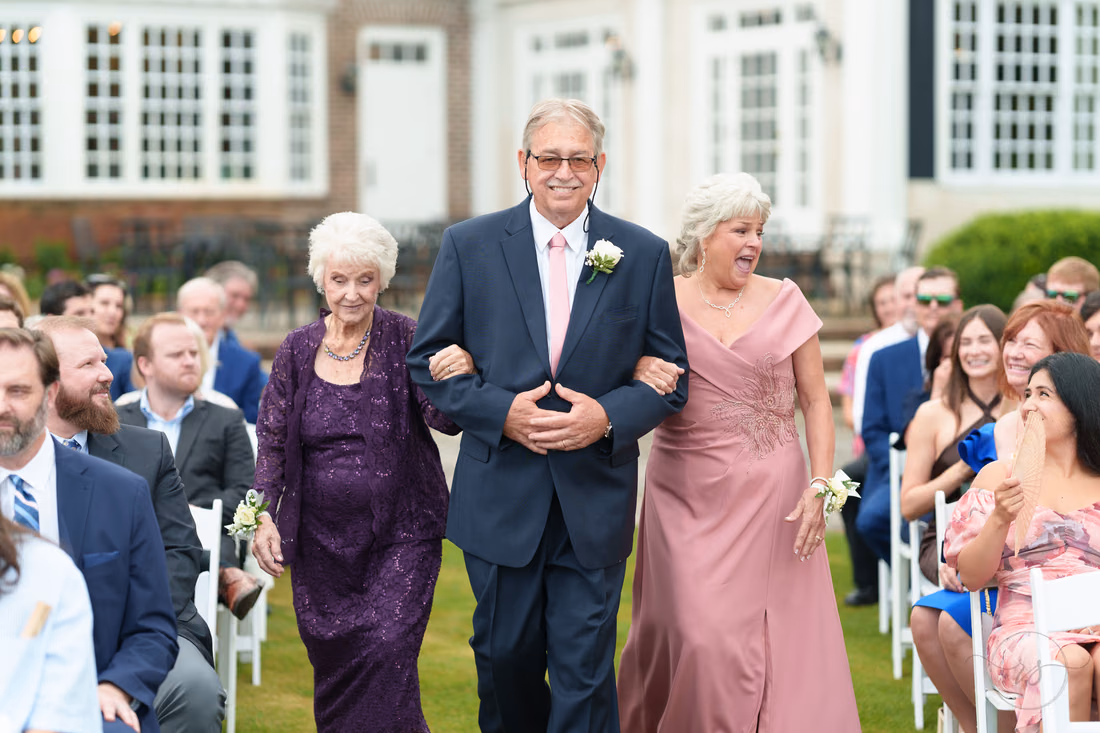 Family members walk down the aisle as the ceremony begins at Pawleys Plantation