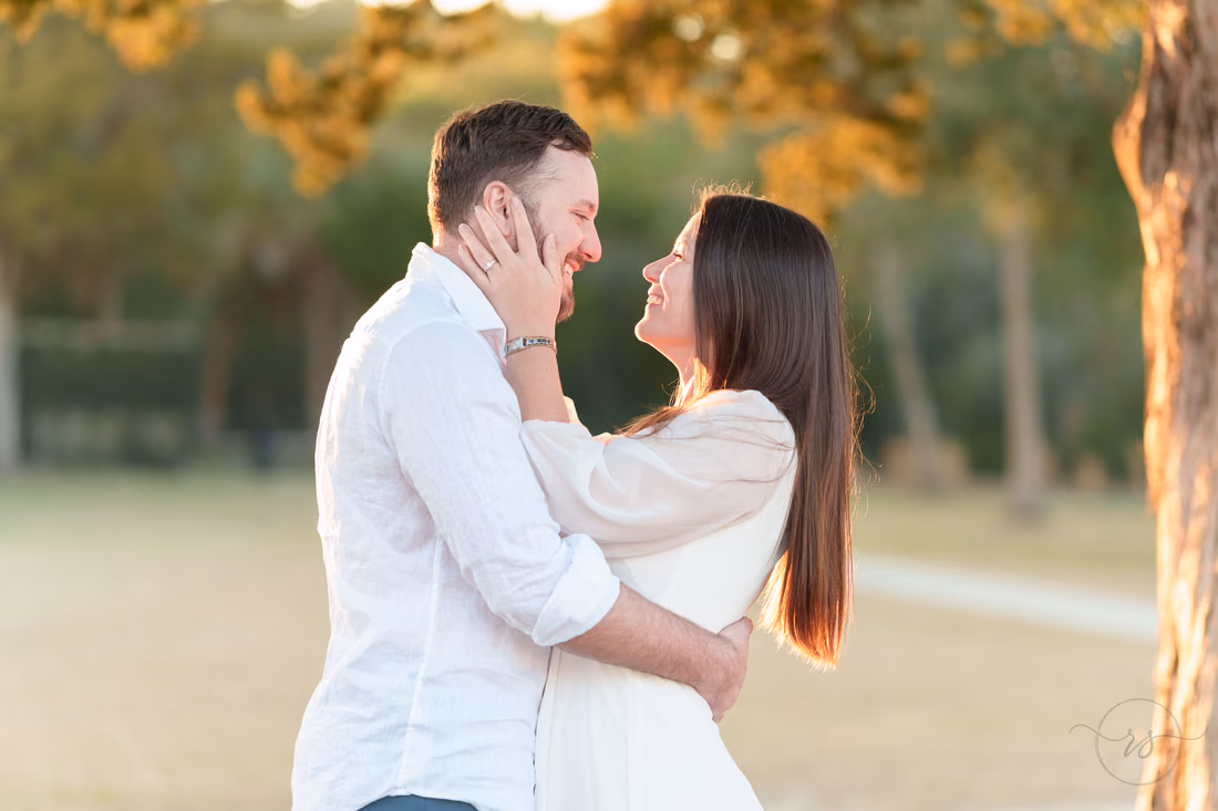 She holds his face under the oaks - Huntington Beach State Park