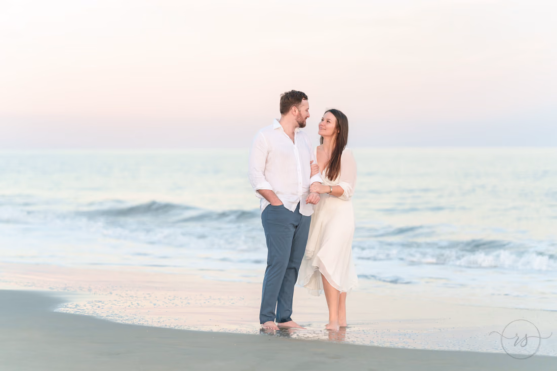 Couple together at the water's edge - Huntington Beach State Park