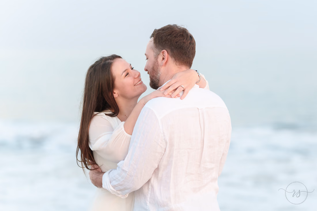 Couple embracing by the waves - Huntington Beach State Park