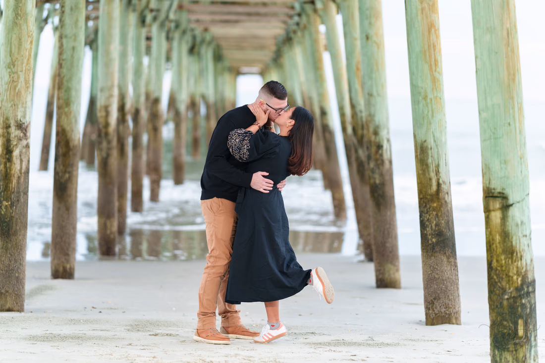 Couple kissing under the pier - Garden City Beach