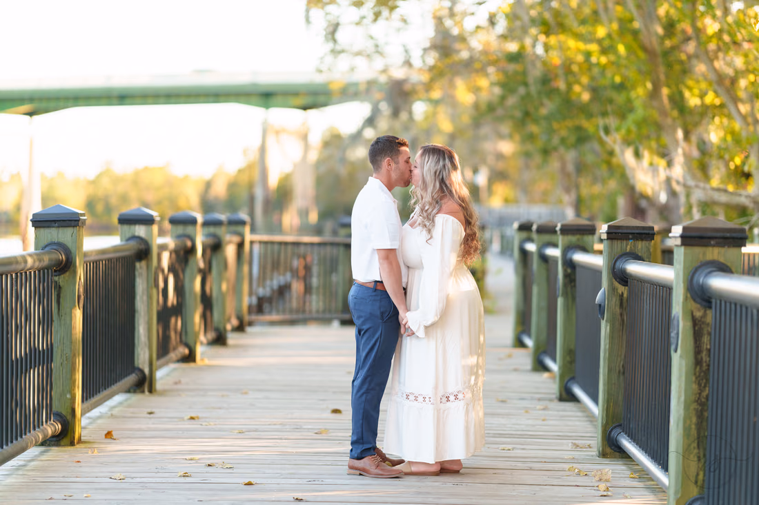Couple kissing on the boardwalk by the river - Conway Riverwalk