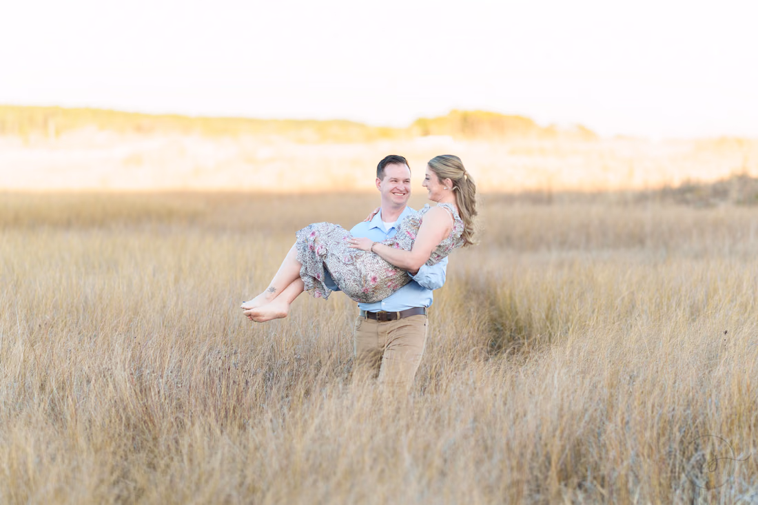 Laughing as he carries her through the tall grass - Cherry Grove Point
