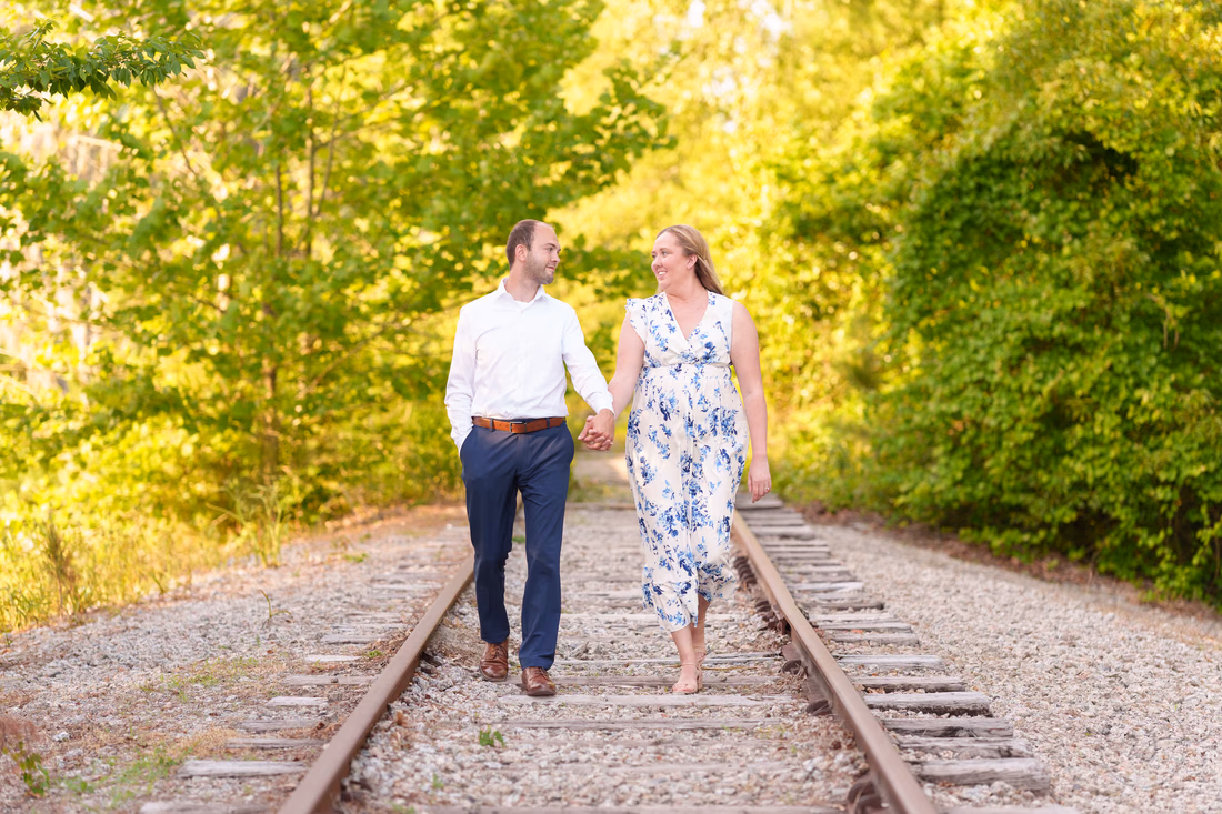 Couple walking on the old train tracks - Conway Riverwalk