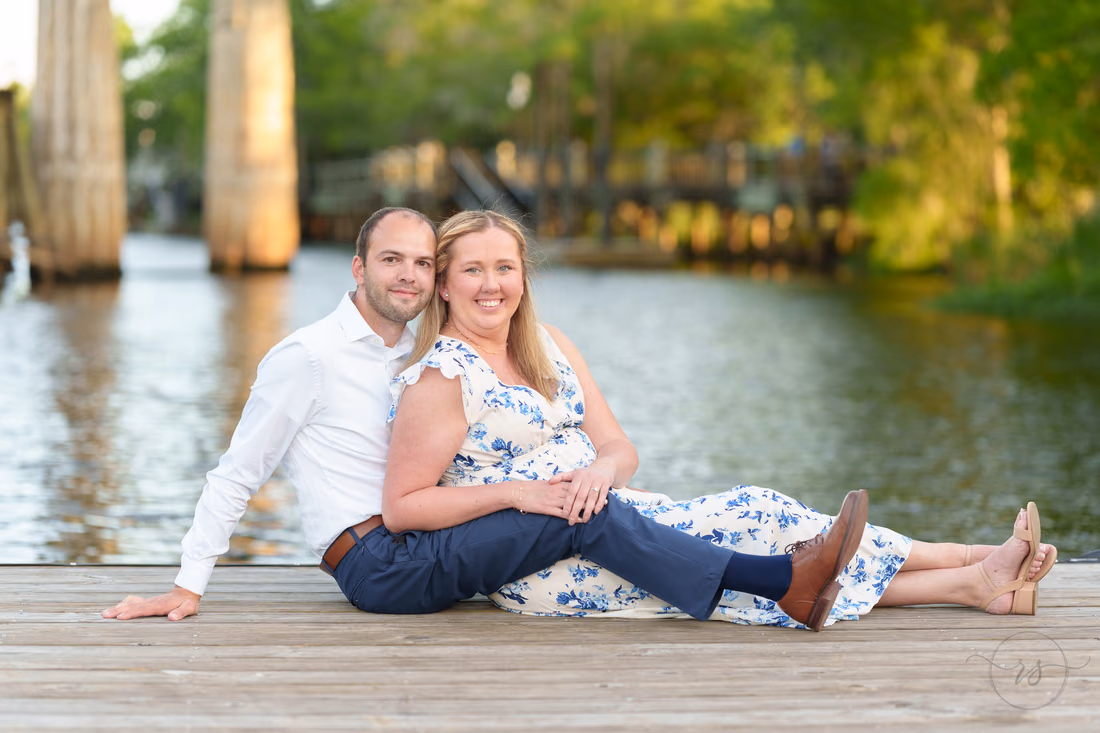 Couple sitting on a dock by the Waccamaw River - Conway Riverwalk