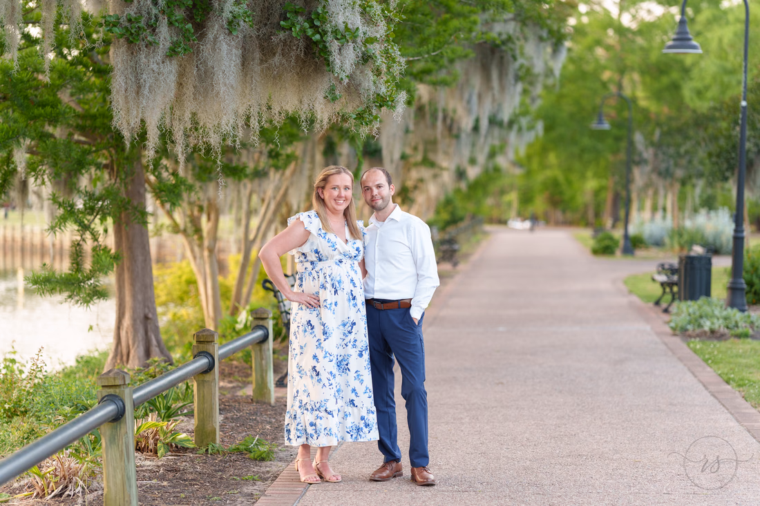 Couple on the paved riverwalk path under mossy oaks - Conway Riverwalk