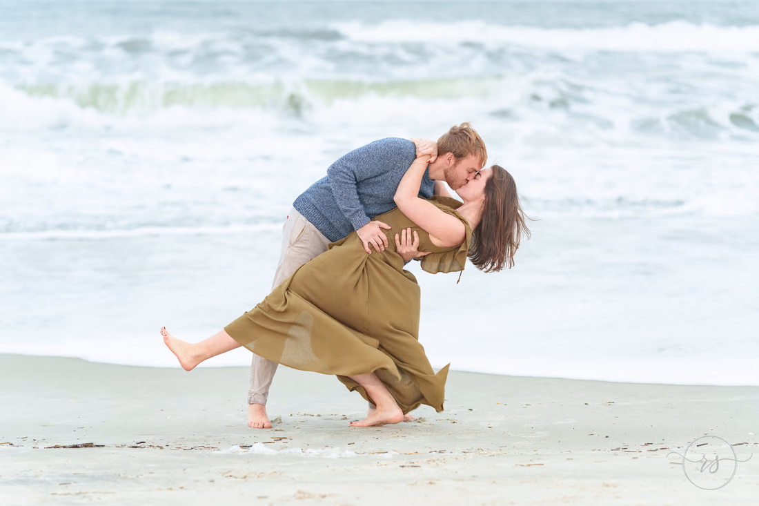 He dips her for a kiss at the water's edge - Huntington Beach State Park