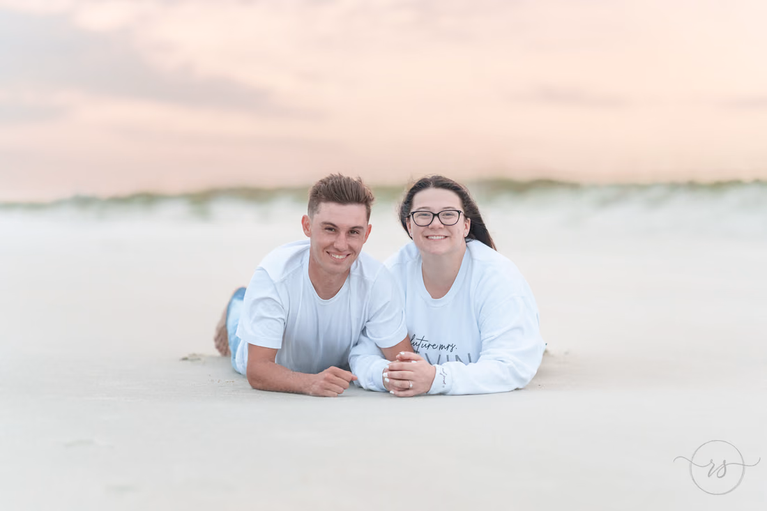 Couple lying in the sand together - Huntington Beach State Park