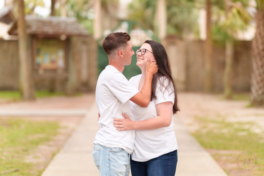 Couple embracing on the path near Atalaya Castle - Huntington Beach State Park
