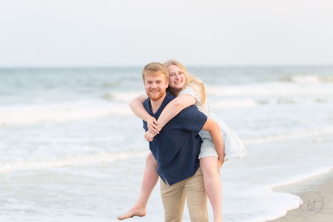 Piggyback ride along the shoreline after the proposal - Huntington Beach State Park