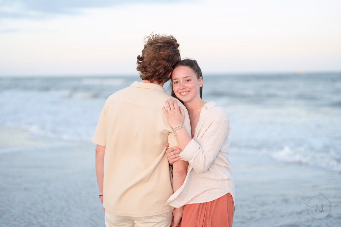 She rests her head on his shoulder by the ocean - Huntington Beach State Park