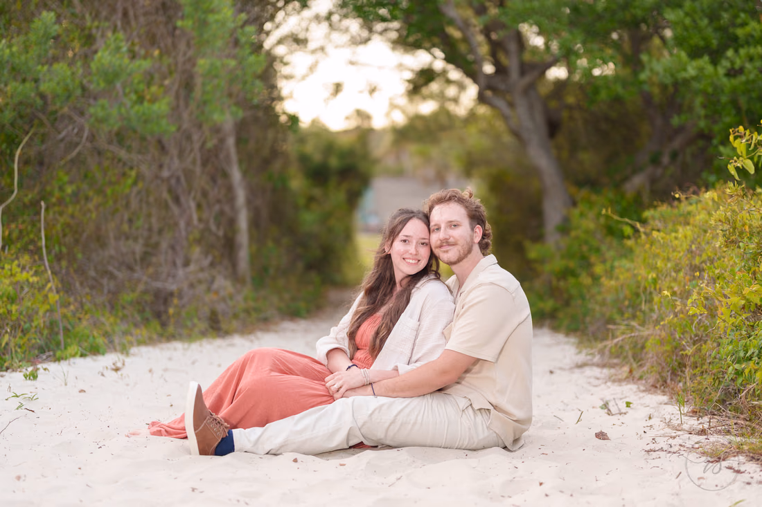 Couple sitting close together on the sandy path - Huntington Beach State Park