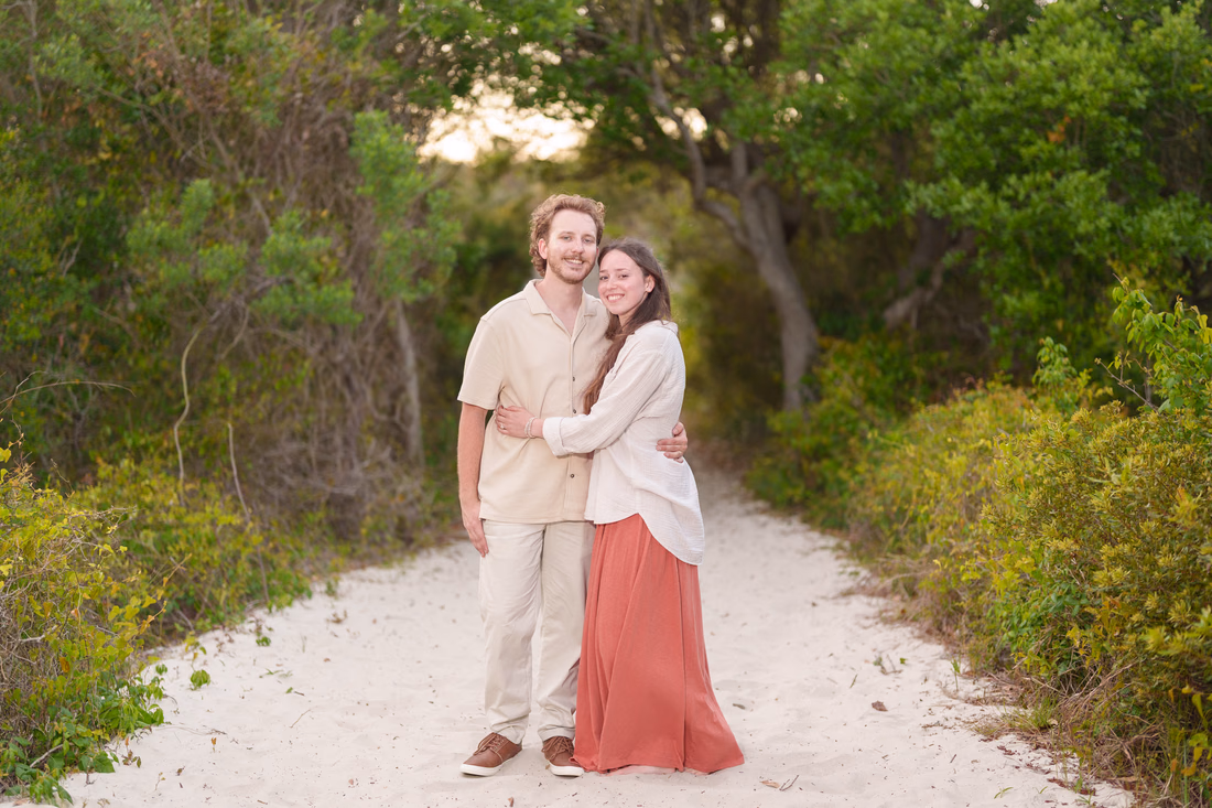 Couple standing arm in arm on the sandy path - Huntington Beach State Park