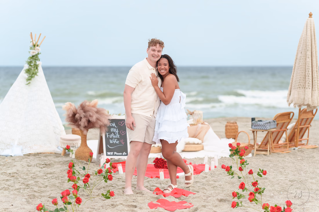Couple smiling by the teepee and rose petals - Myrtle Beach