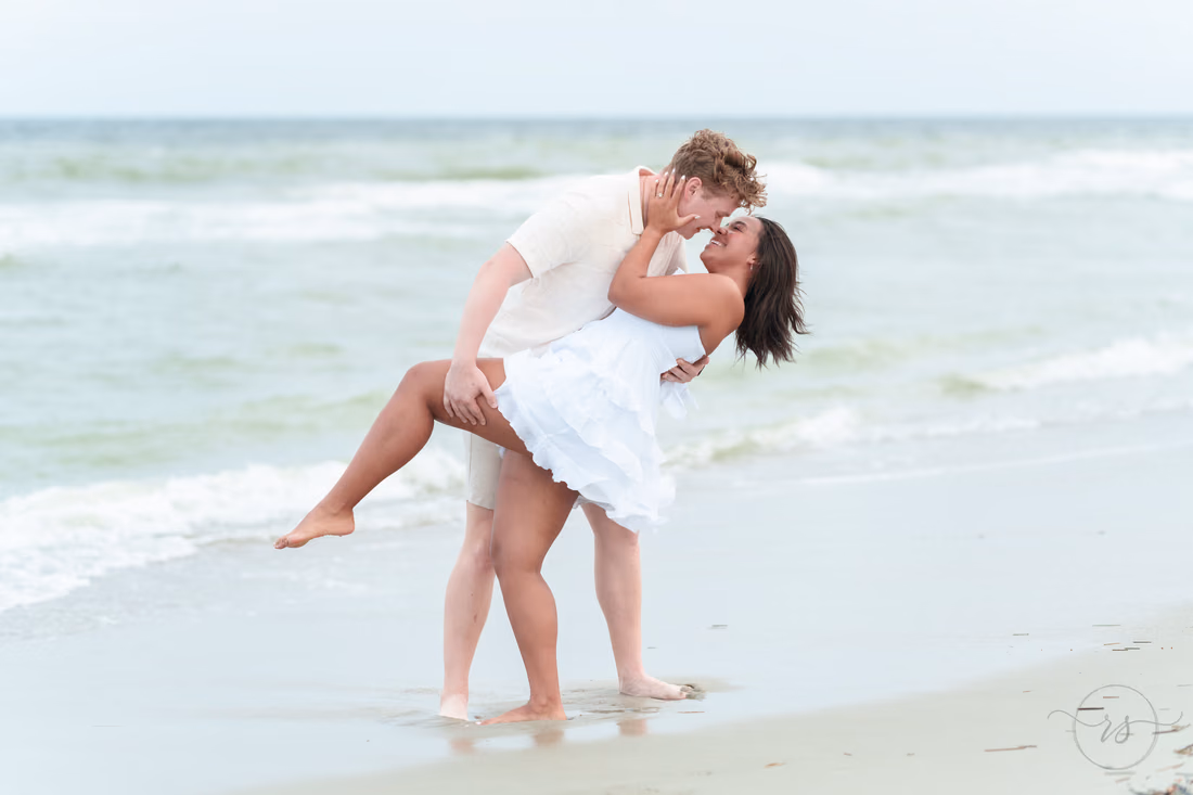 He dips her for a kiss in the surf - Myrtle Beach