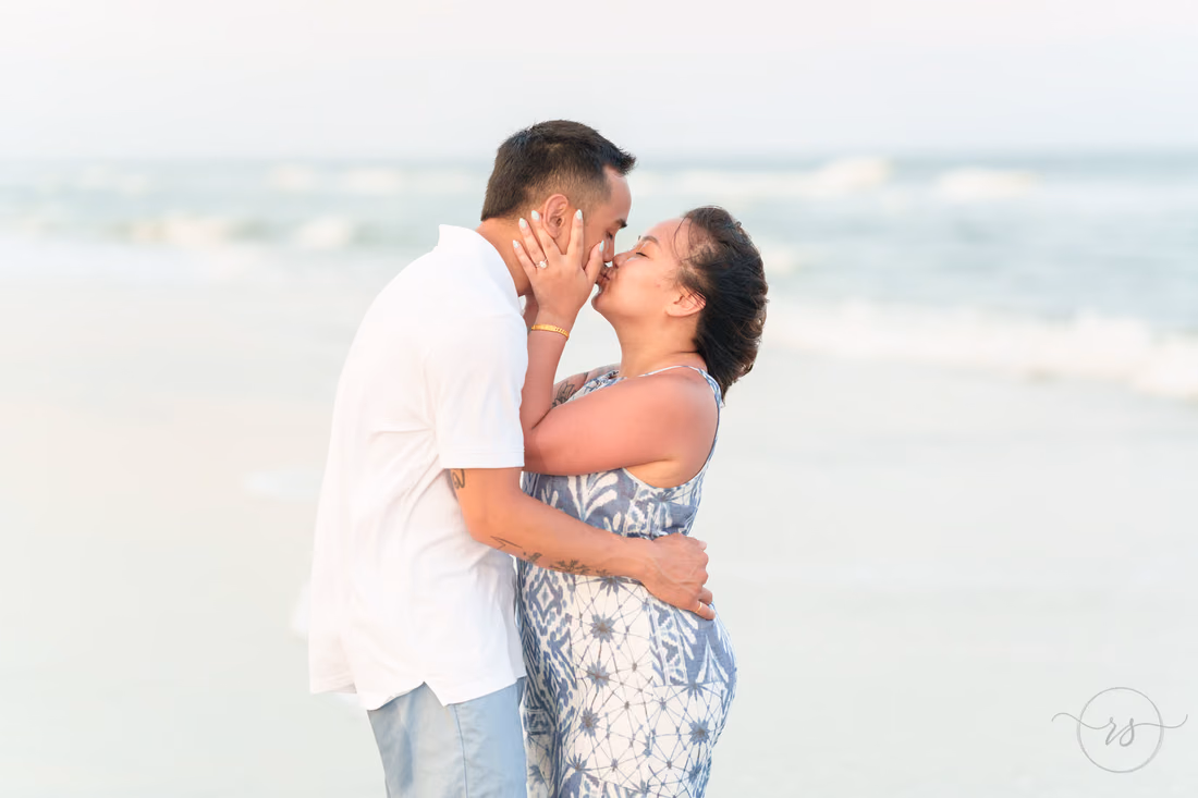 Couple sharing a kiss by the ocean - Huntington Beach State Park