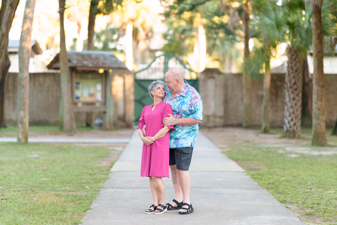 Older couple on the path by the Atalaya Castle gate - Huntington Beach State Park