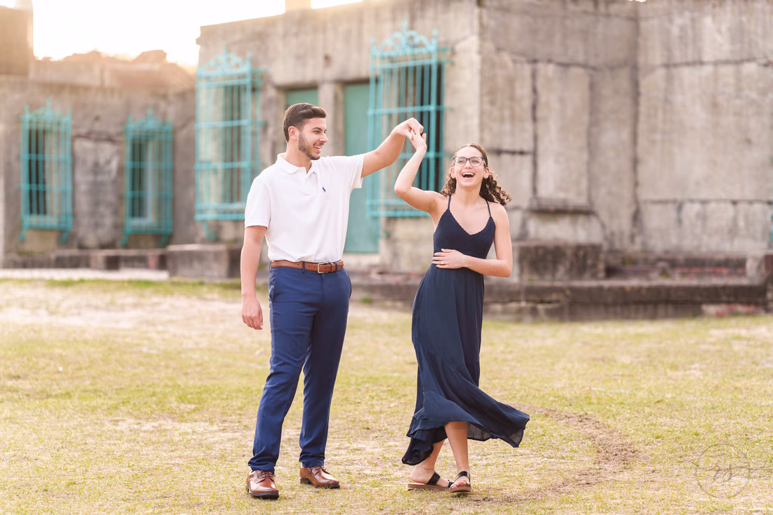 He twirls her on the lawn in front of Atalaya Castle - Huntington Beach State Park