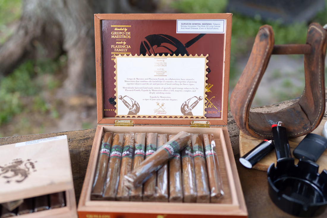 Box of cigars and lighters beside a saddle stirrup at the cigar bar at Wildhorse at Parker Farms